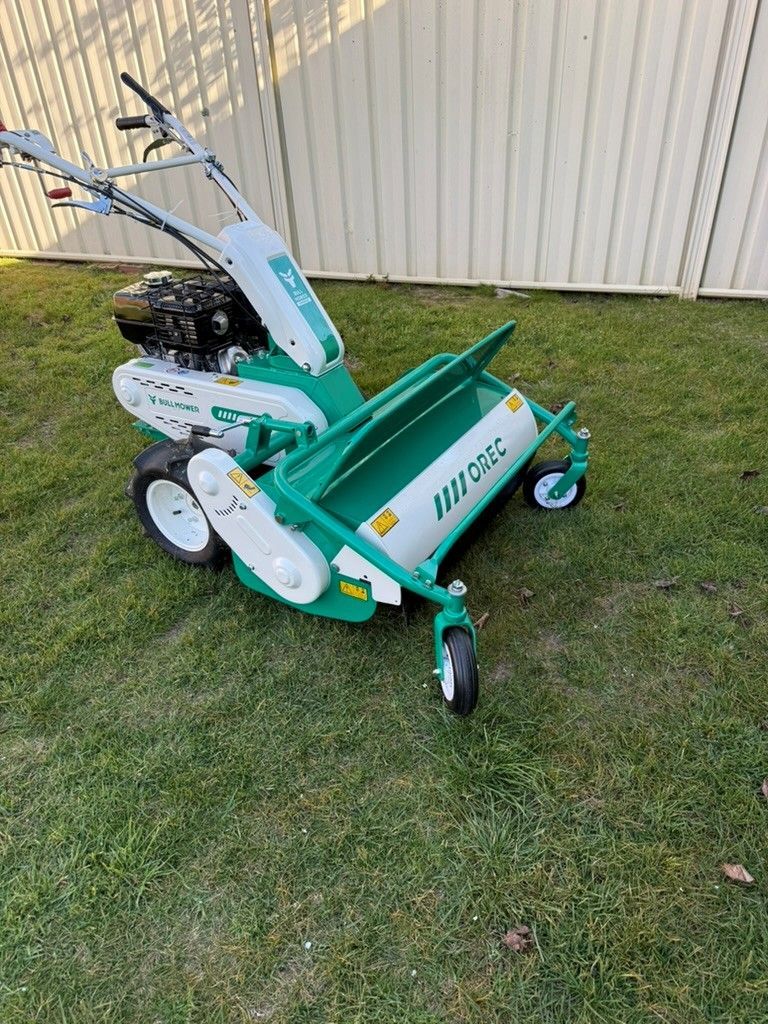 Close view of a pedestrian flail mower for dense grass