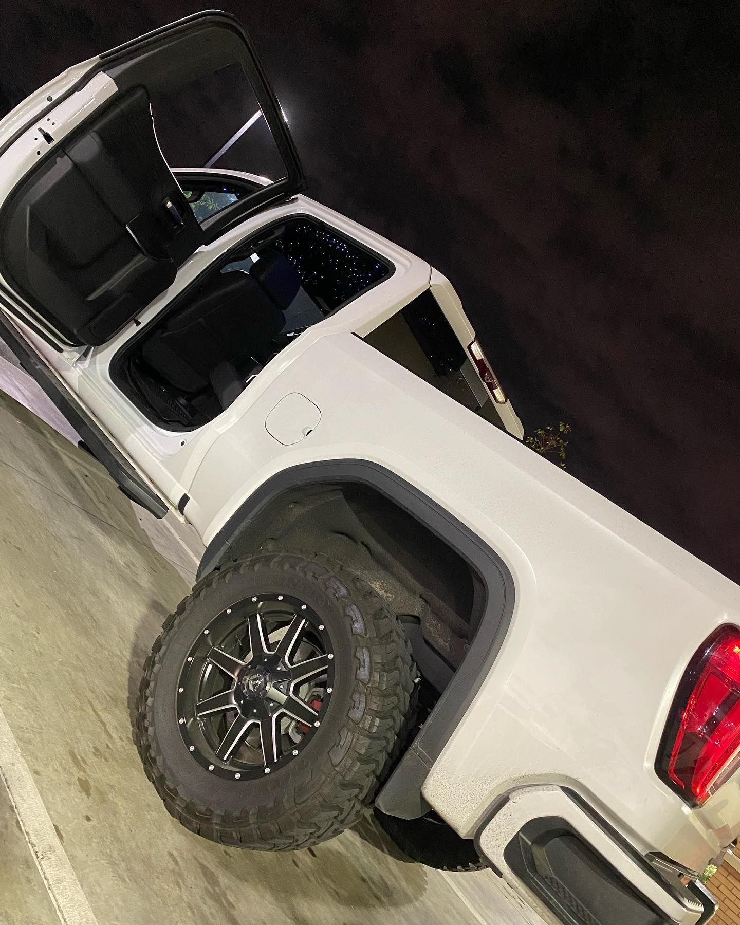 Custom starlight headliner installation in a white vehicle