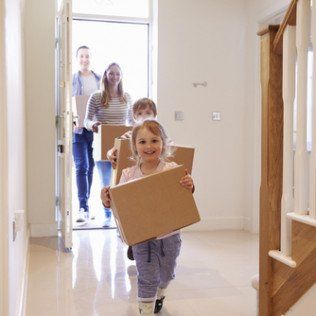 family carrying boxes