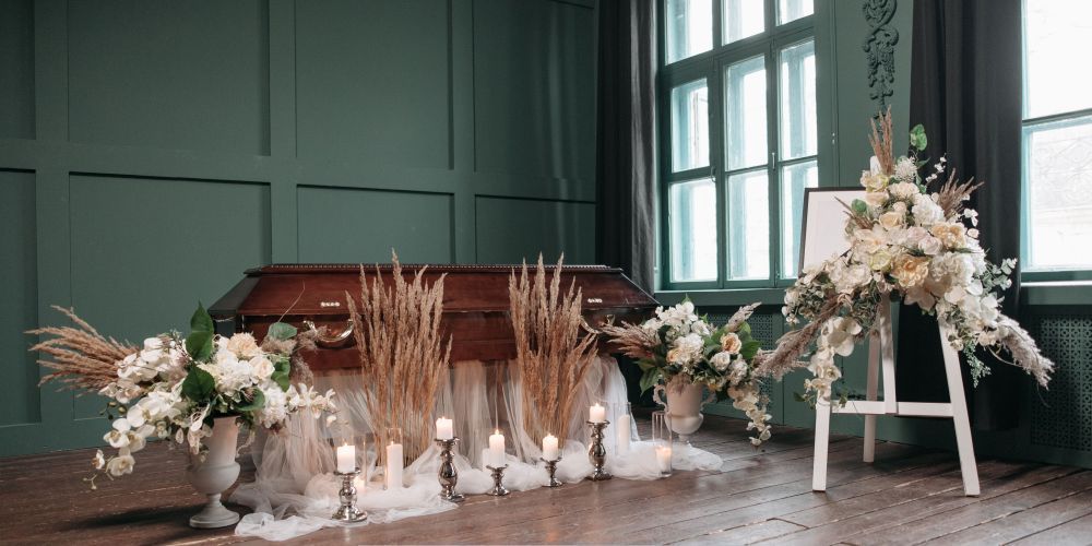 Elegant funeral casket with floral arrangements and candles during a memorial ceremony at a trusted funeral home and cremation service in Parkville, PA