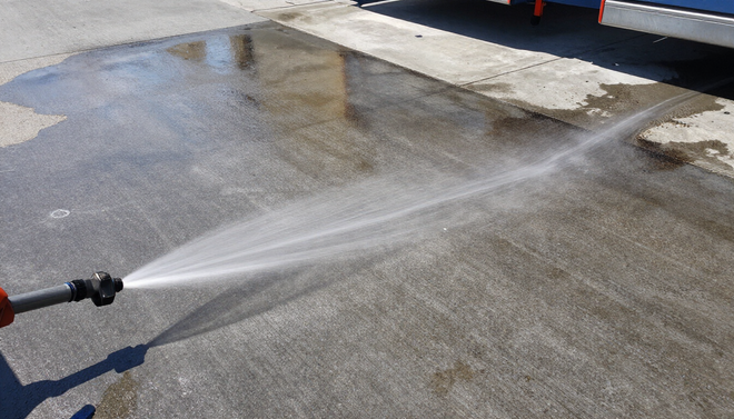 Pressure washing commercial concrete loading dock