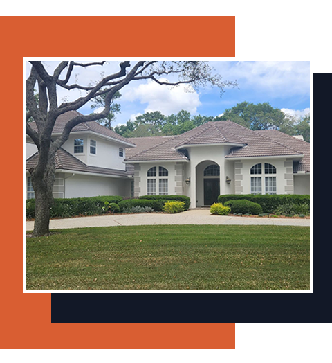 Suburban house with white arches, beige roof, green lawn, and a tree in front
