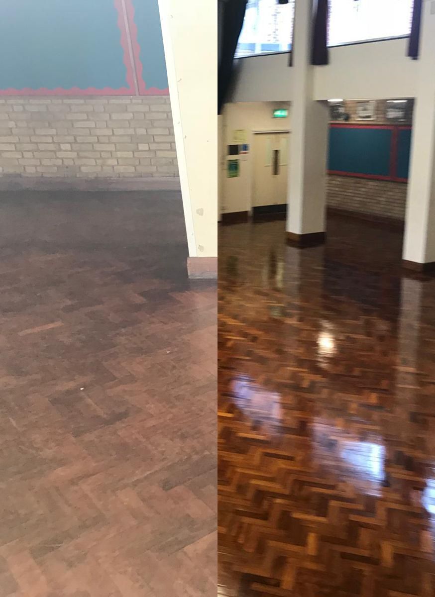 Wooden floor, half dull, half highly polished, in a building with white pillars and brick wall.