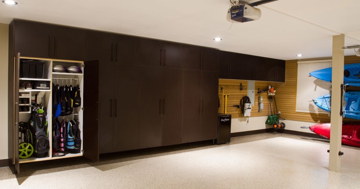 Commercial kitchen with stainless steel appliances and speckled floor.