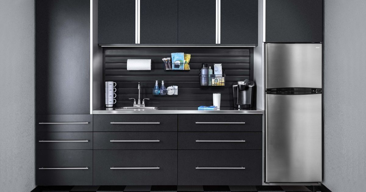 Black garage kitchen with stainless steel appliances and a sink.