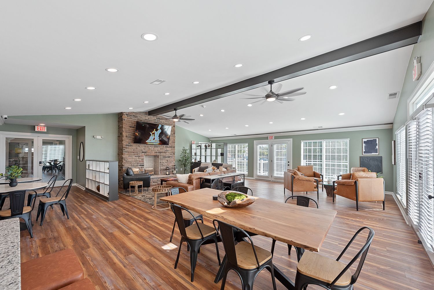 A large room with a table and chairs in it.