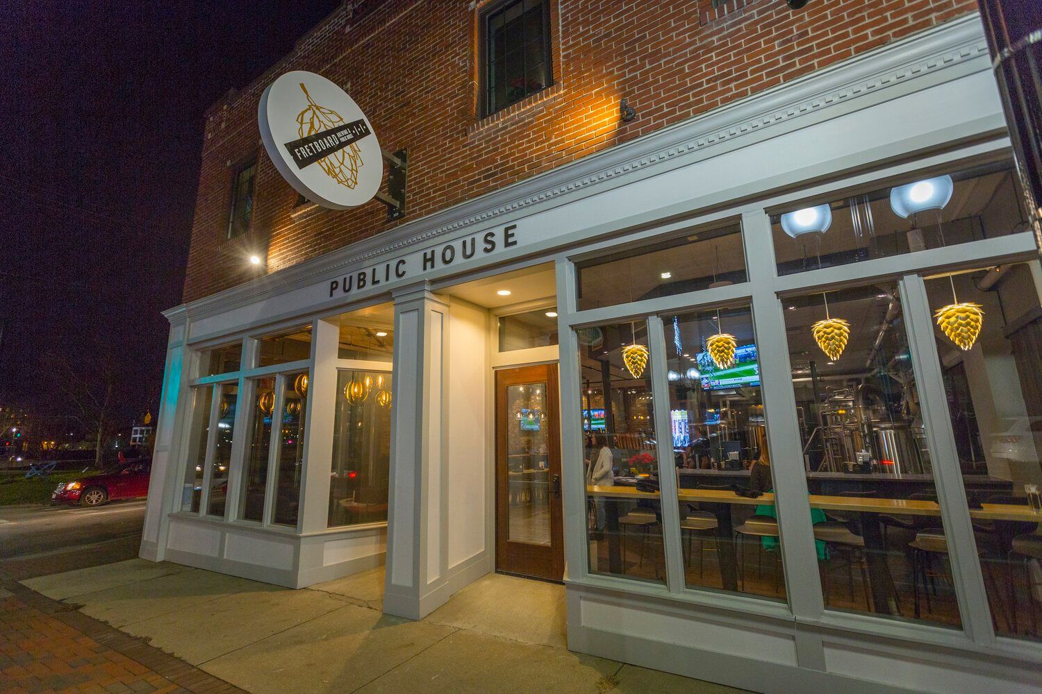 A restaurant called public house is located in a brick building.