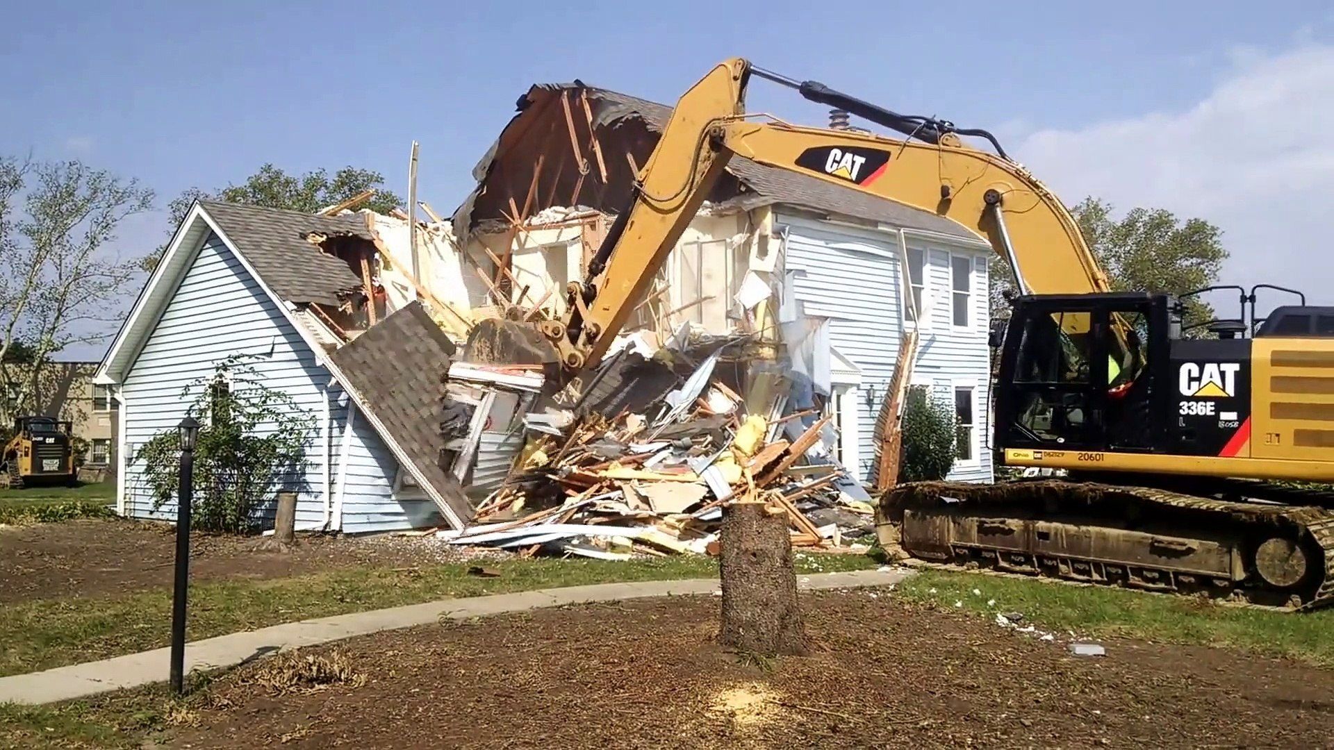 excavator demolishing house in kansas city