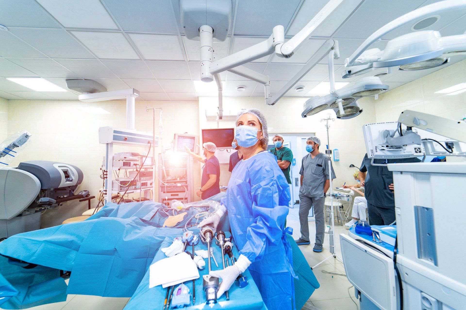 A group of surgeons are performing surgery in an operating room.