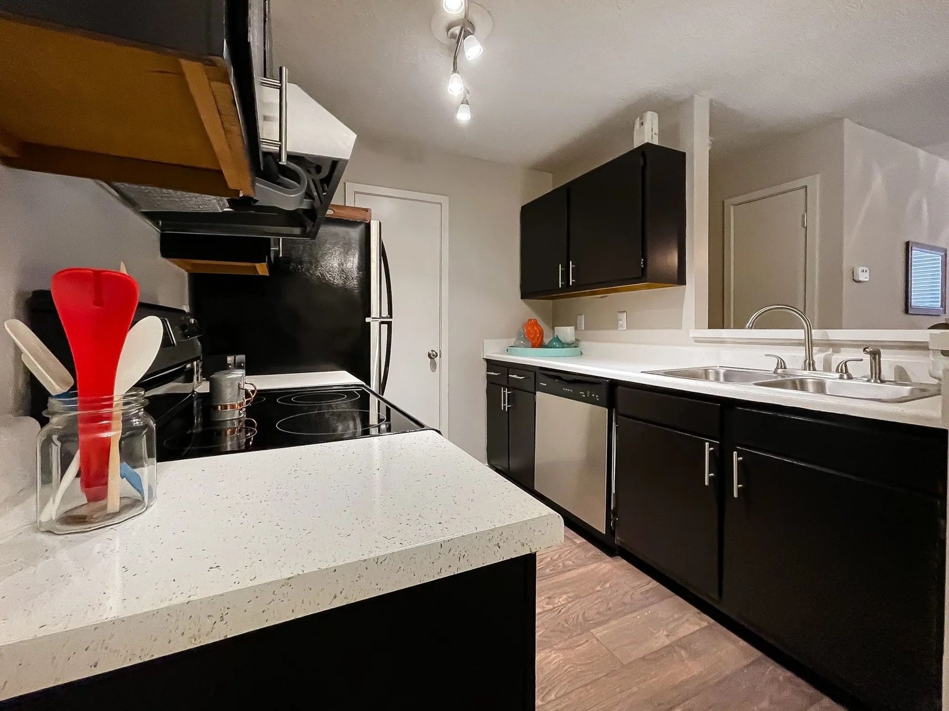 Modern kitchen with black cabinets and white countertops