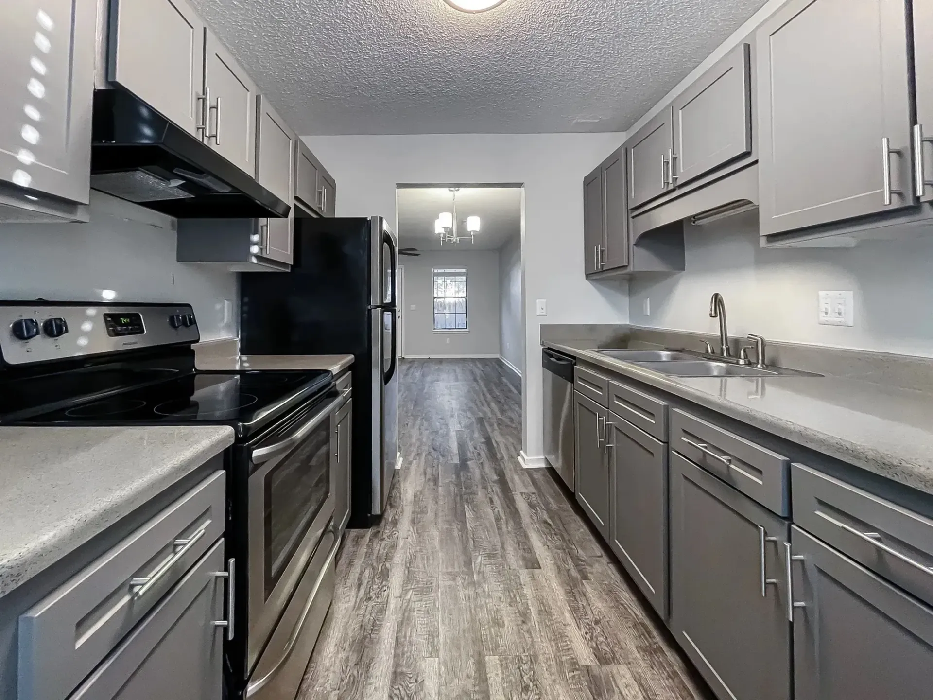 Modern kitchen with stainless steel appliances and gray cabinets