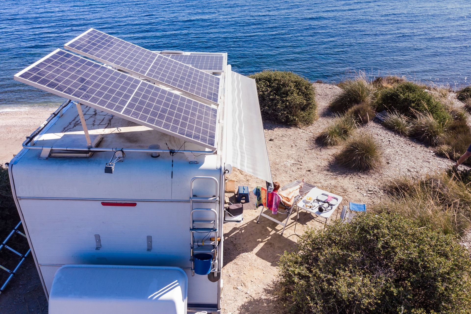 Solar Panels Atop a White Structure on a Rocky Shore, Near the Water — Caravan and Trailer Clinic Geelong in Breakwater, VIC