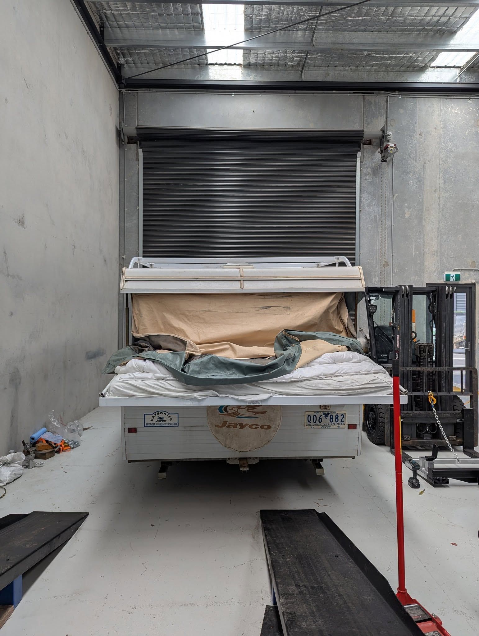 Trailer Loaded With Fabric Sits Inside a Warehouse — Caravan and Trailer Clinic Geelong in Breakwater, VIC