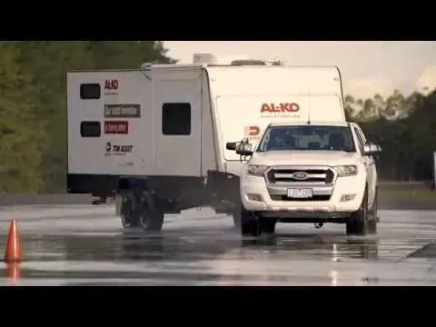 White Ford Truck Towing a White Caravan on a Wet Track — Caravan and Trailer Clinic Geelong in Breakwater, VIC