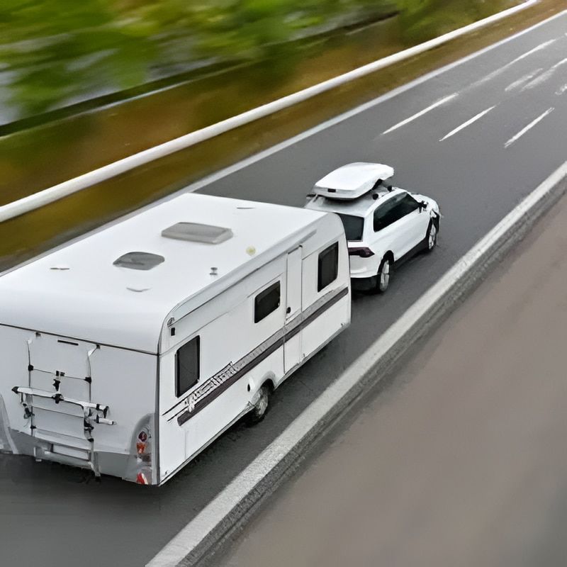 White Suv Towing a White Camper on a Highway — Caravan and Trailer Clinic Geelong in Breakwater, VIC
