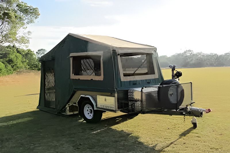 Green Pop-up Camper Trailer on a Grassy Field — Caravan and Trailer Clinic Geelong in Breakwater, VIC