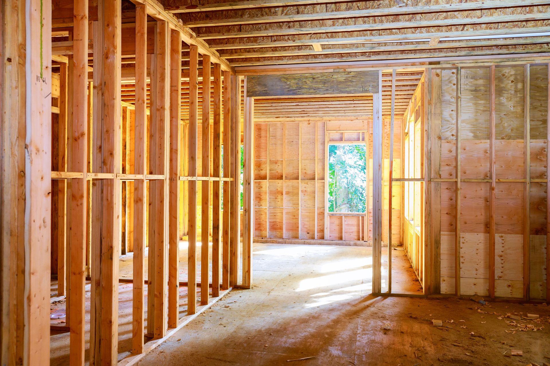 The inside of a house under construction with wooden beams.