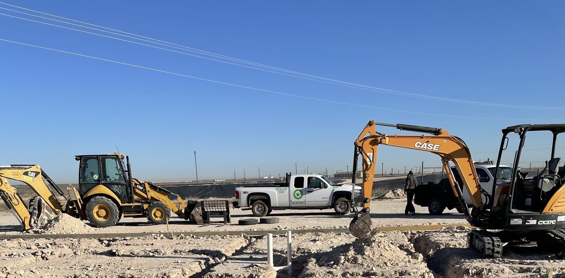 a construction site with a yellow excavator in the background