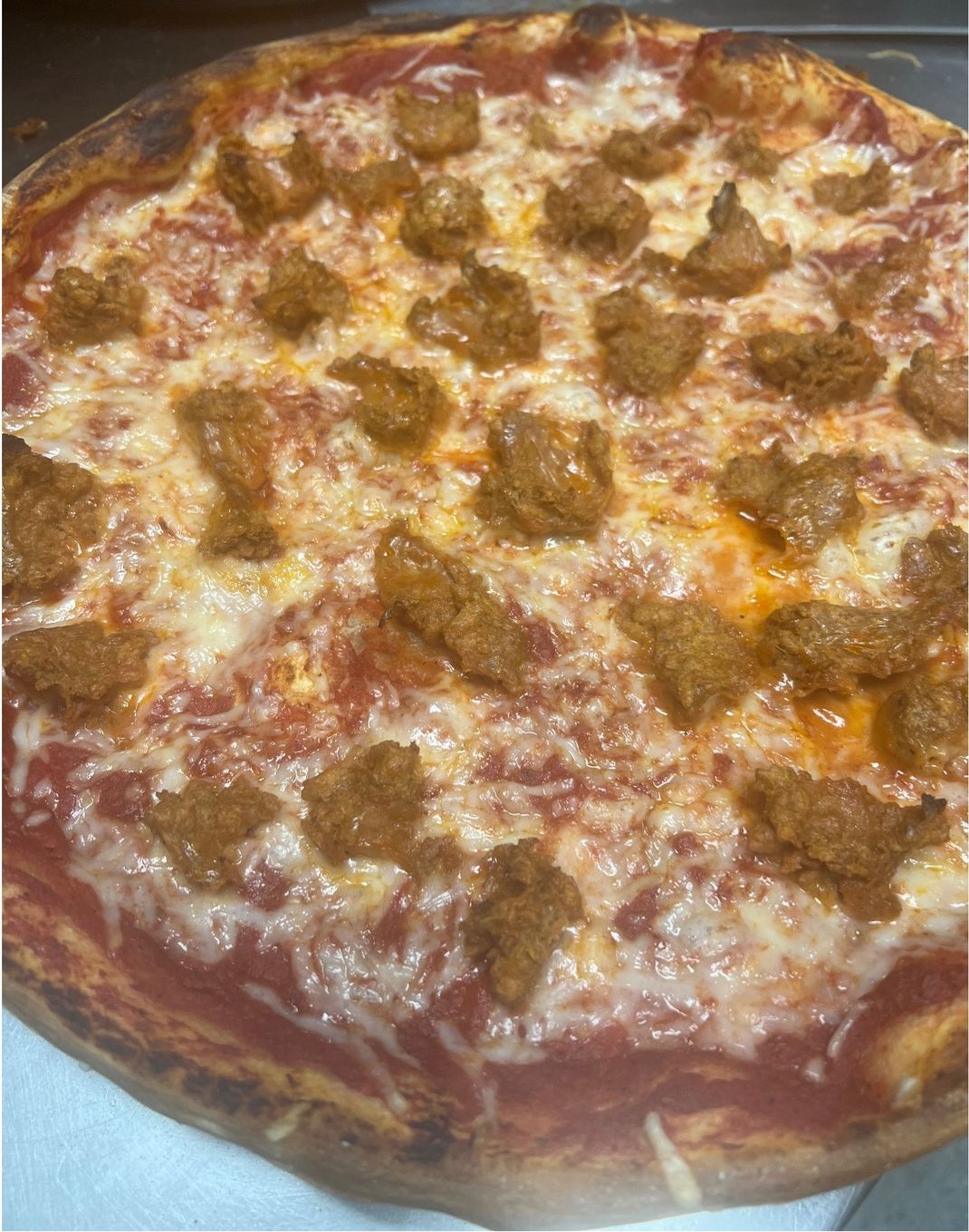 vegan cheese pizza topped vegan sausage