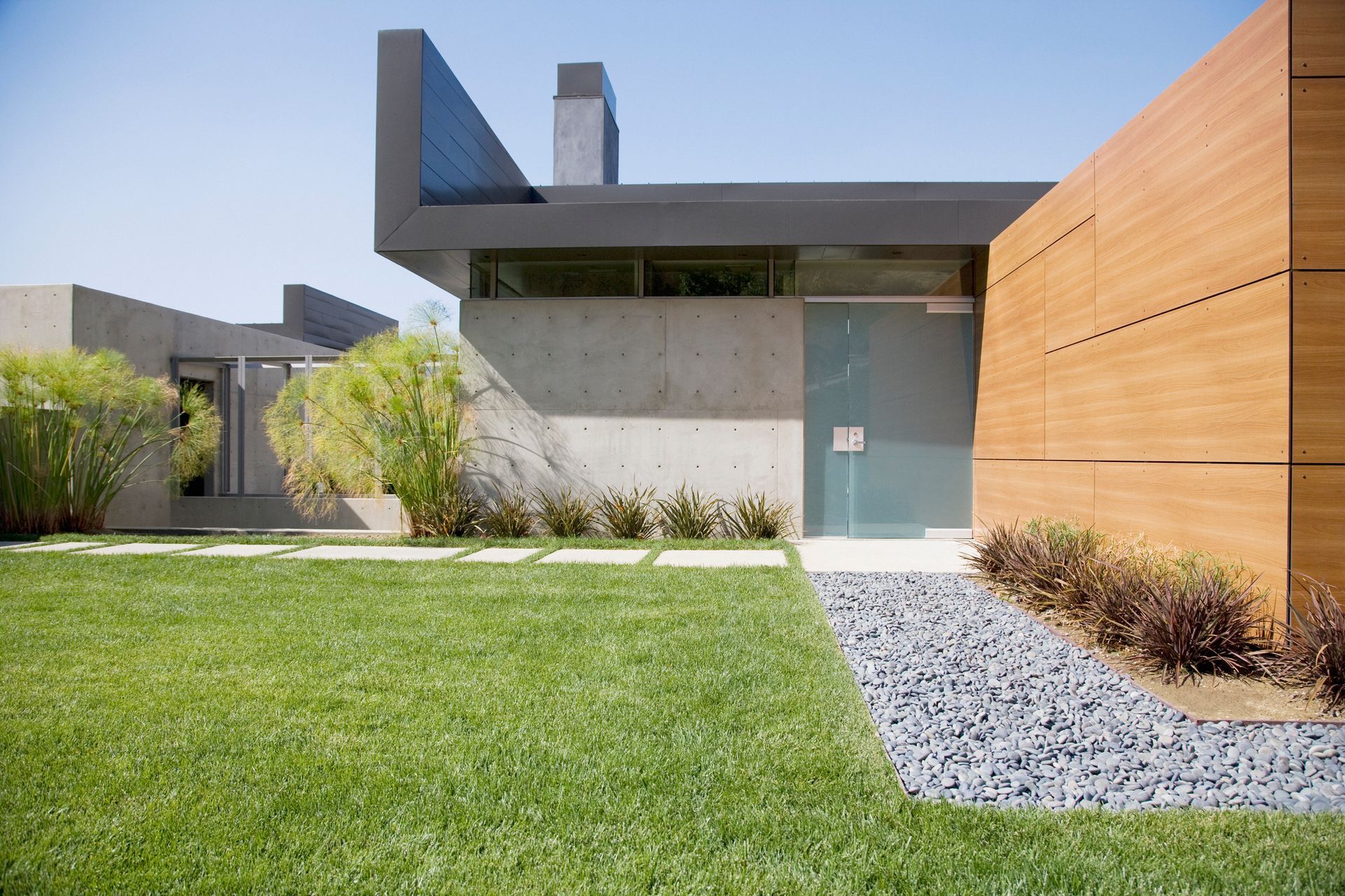 A house with a large lawn in front of it