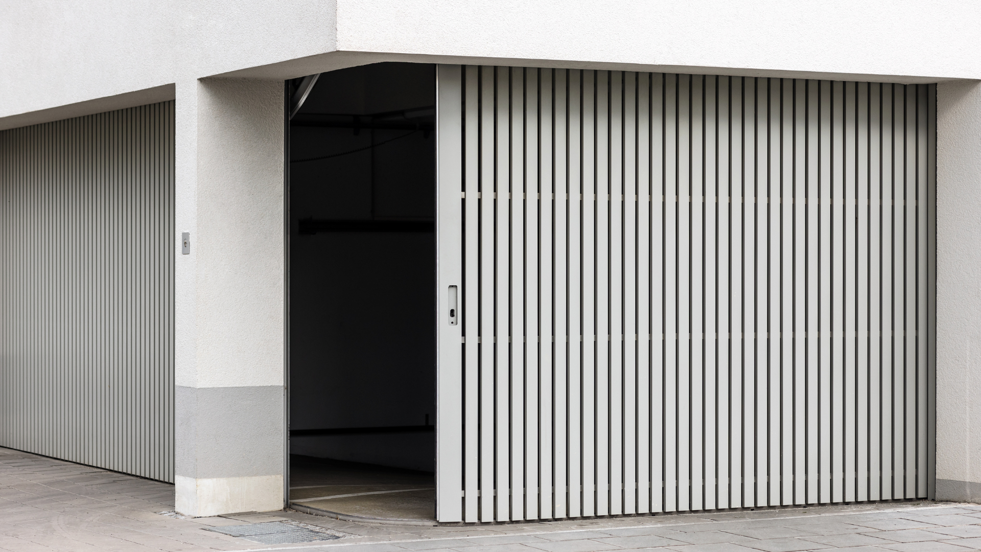 A garage with a sliding door that is open.