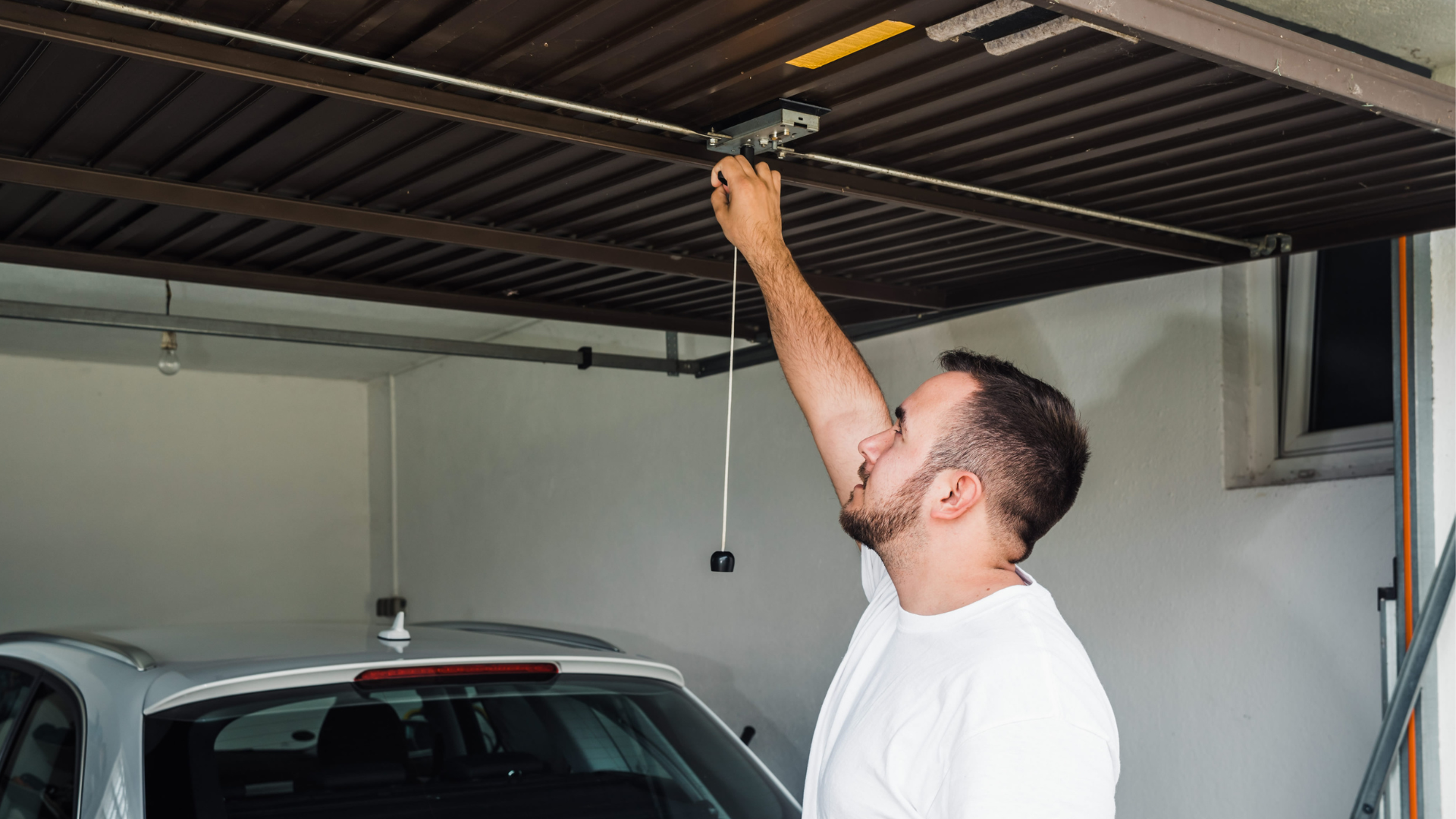 A man looking at his faulty garage door.
