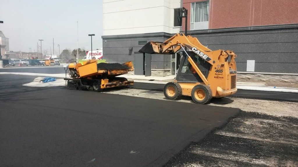 A case construction vehicle is working on a road