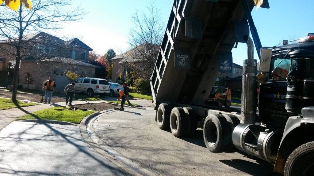 A dump truck is parked on the side of the road