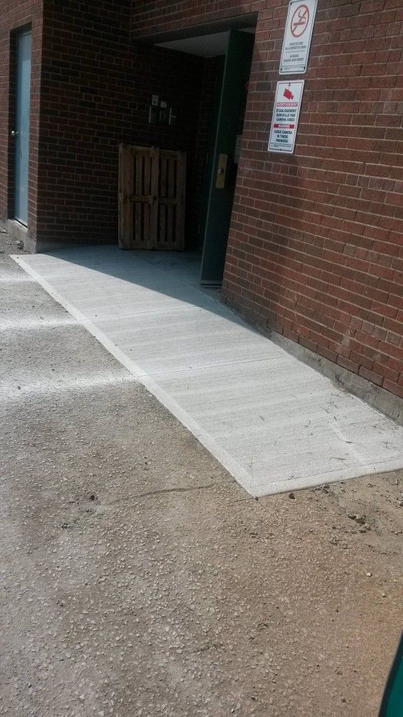 A brick building with a ramp leading to it.