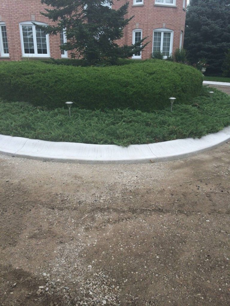 A brick house with a circular walkway in front of it