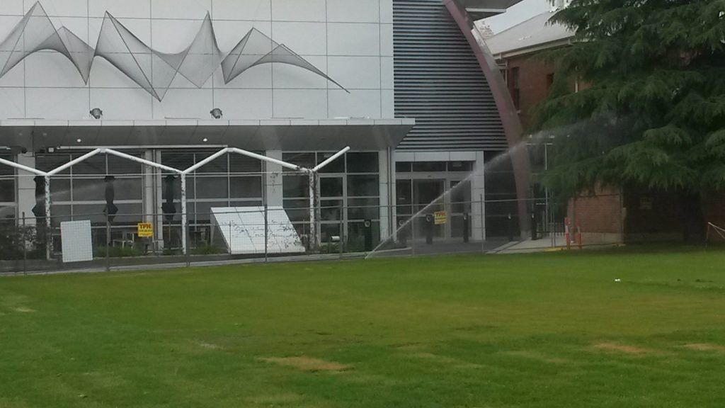 A Sprinkler Spraying Water on a Grass Field — Pumps Sales & Repairs in Albury, NSW