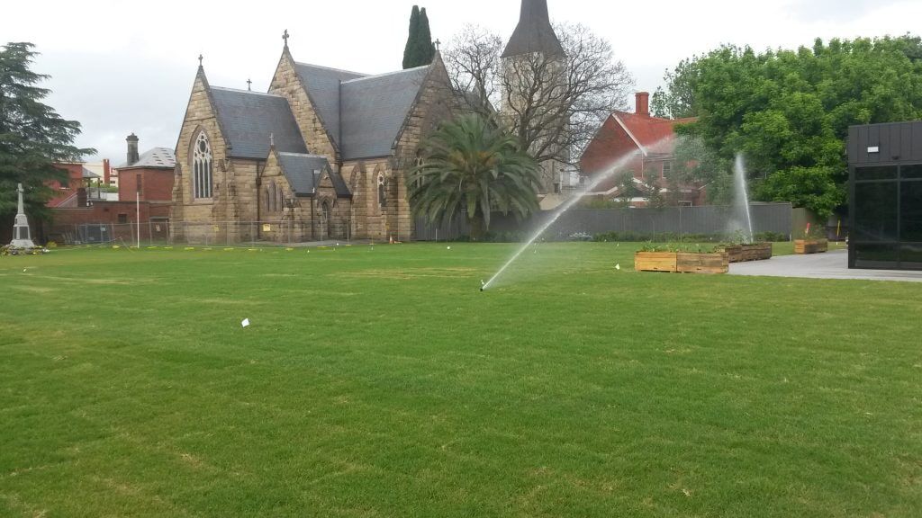 Spacious Lawn Being Watered By A Sprinkler — Pumps Sales & Repairs in Albury, NSW