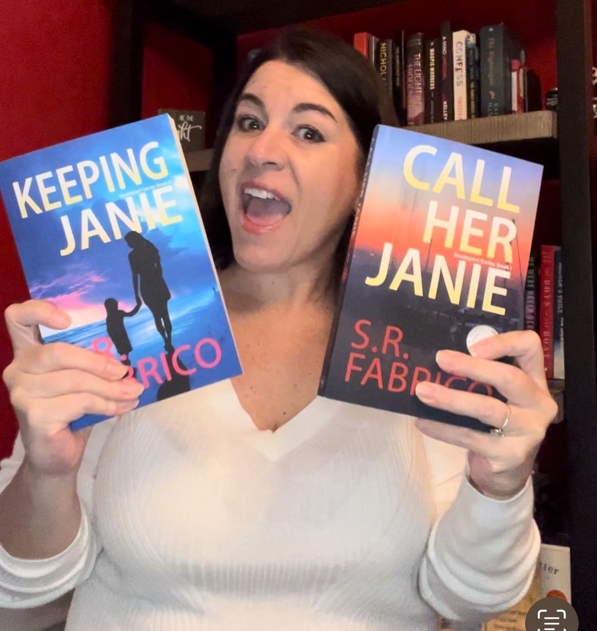 A woman is holding two books titled keeping jane and call her janie