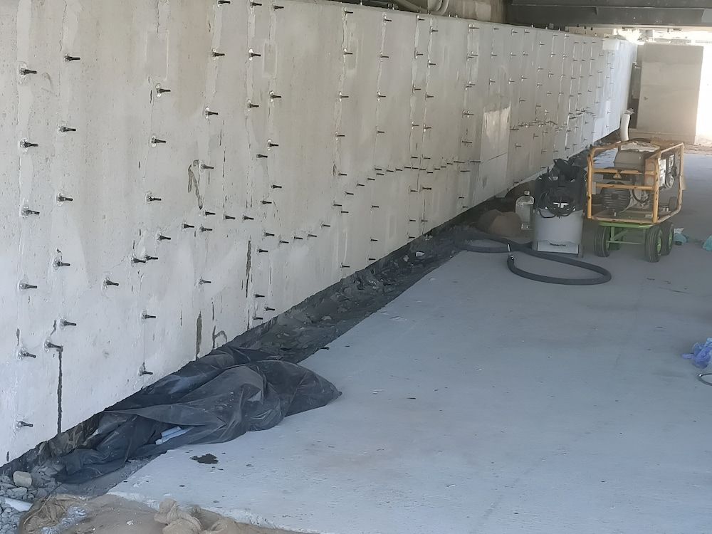 Concrete wall with numerous metal pins, undergoing construction. — Unique Waterproofing Solutions in North Rocks, NSW
