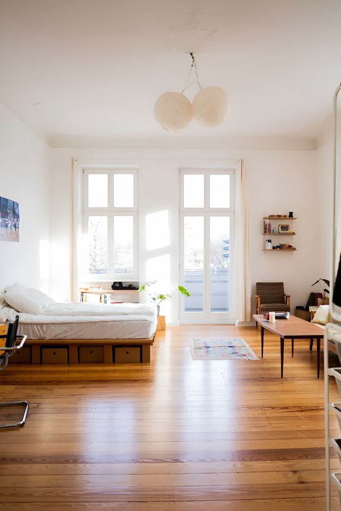 Bright, Airy Bedroom With Hardwood Floors, Bed and Large Windows — Unique Waterproofing Solutions in North Rocks, NSW