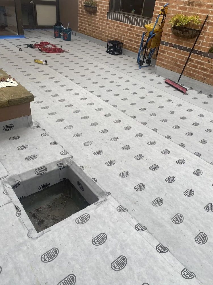 Flat Roof With Patterned Membrane, Open Access Square, Brick Wall — Unique Waterproofing Solutions in North Rocks, NSW