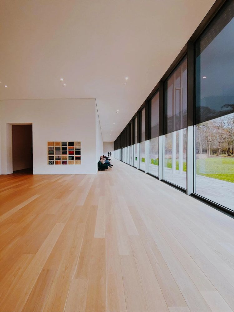 Long, Light-wood Floored Hallway With Large Windows, Bright White Walls — Unique Waterproofing Solutions in North Rocks, NSW