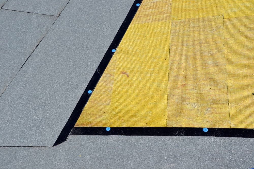 Gray and Yellow Roofing Materials, With a Black Strip Secured — Unique Waterproofing Solutions in North Rocks, NSW