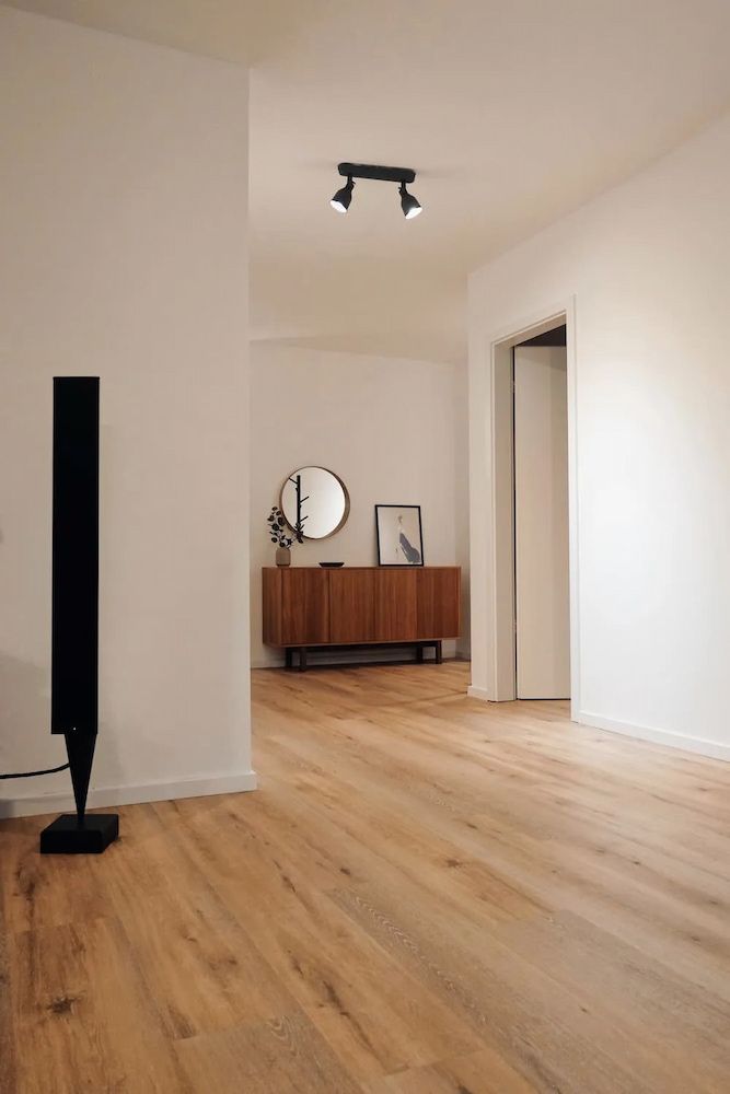 Empty Hallway With Light Wooden Floors and White Walls — Unique Waterproofing Solutions in North Rocks, NSW