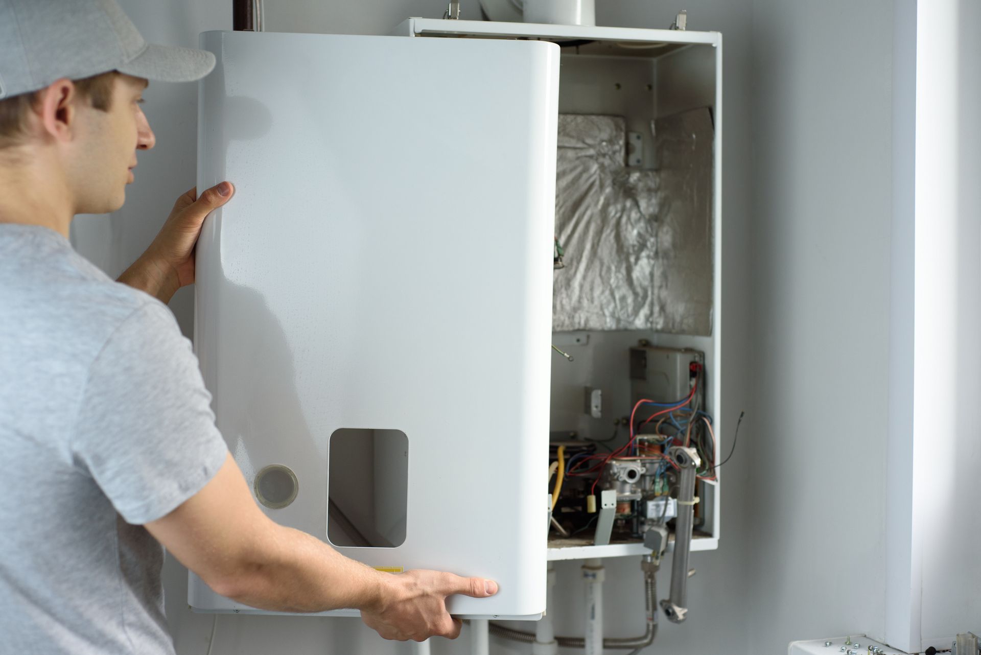 HVAC technician performing boiler maintenance on a home heating system in Endicott, New York.