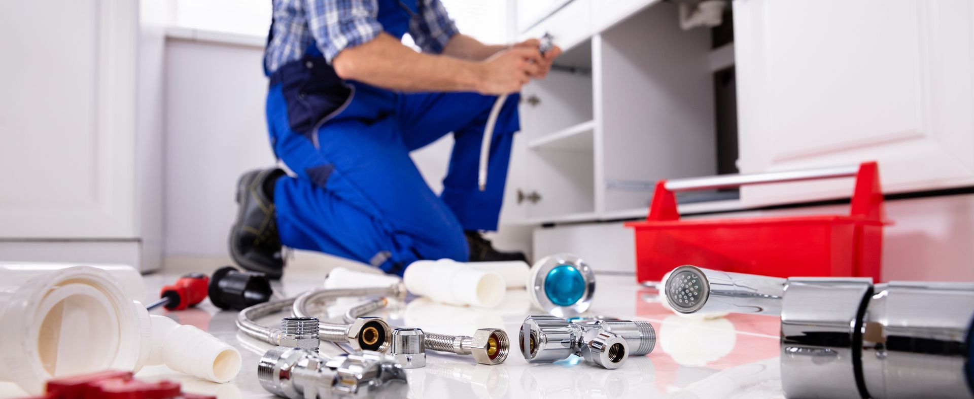 Evans Plumbing & Heating plumber repairing residential plumbing system in a Binghamton, NY home.