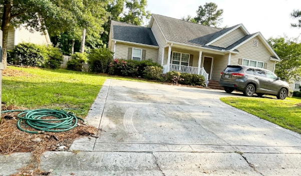 A beautiful, newly installed concrete and stamped border driveway at a home in Summerville, SC, showing high curb appeal.