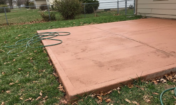 Custom colored concrete patio installation.