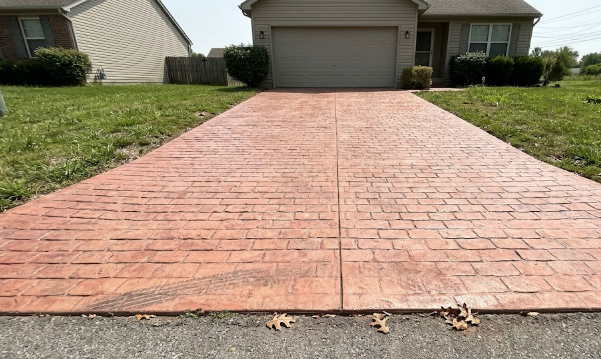 Stamped concrete driveway designed to look like classic cobblestone bricks.