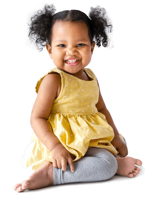 Baby wrapped in a white towel, smiling, looking upward on a white background.