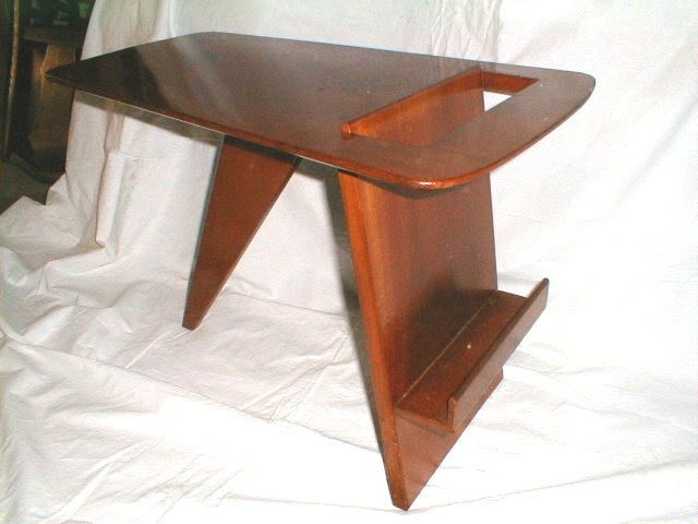 Wooden folding TV tray table with brown finish on a white cloth background