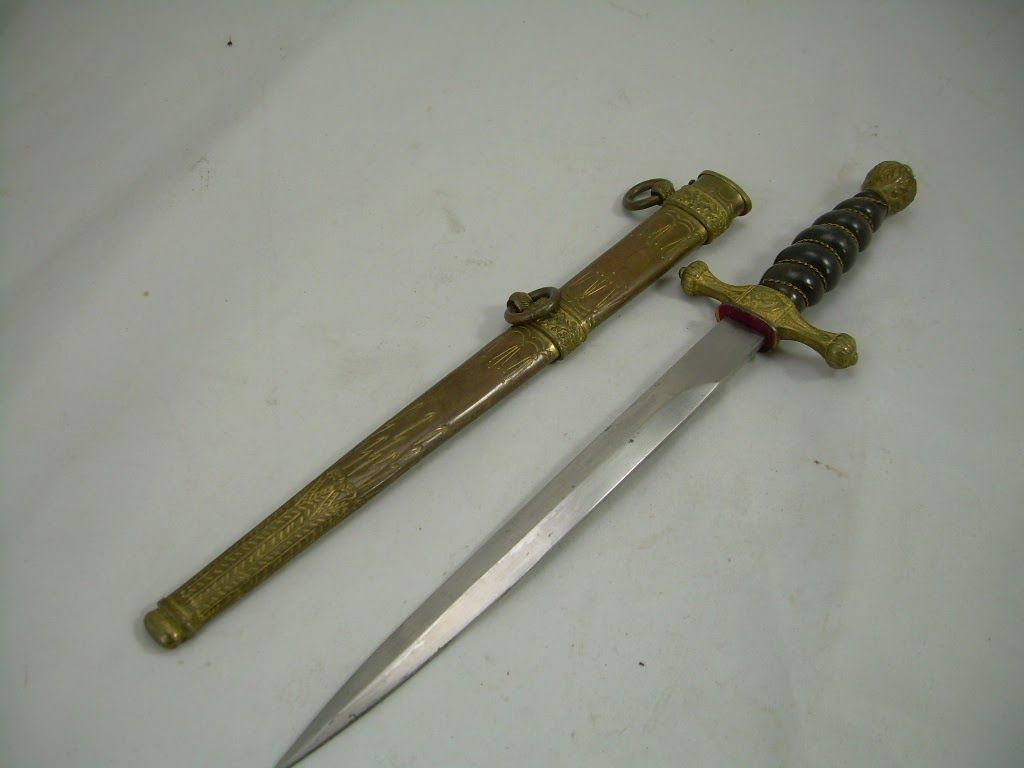 Two ornate swords in gold sheaths, one unsheathed with a silver blade on a white background.