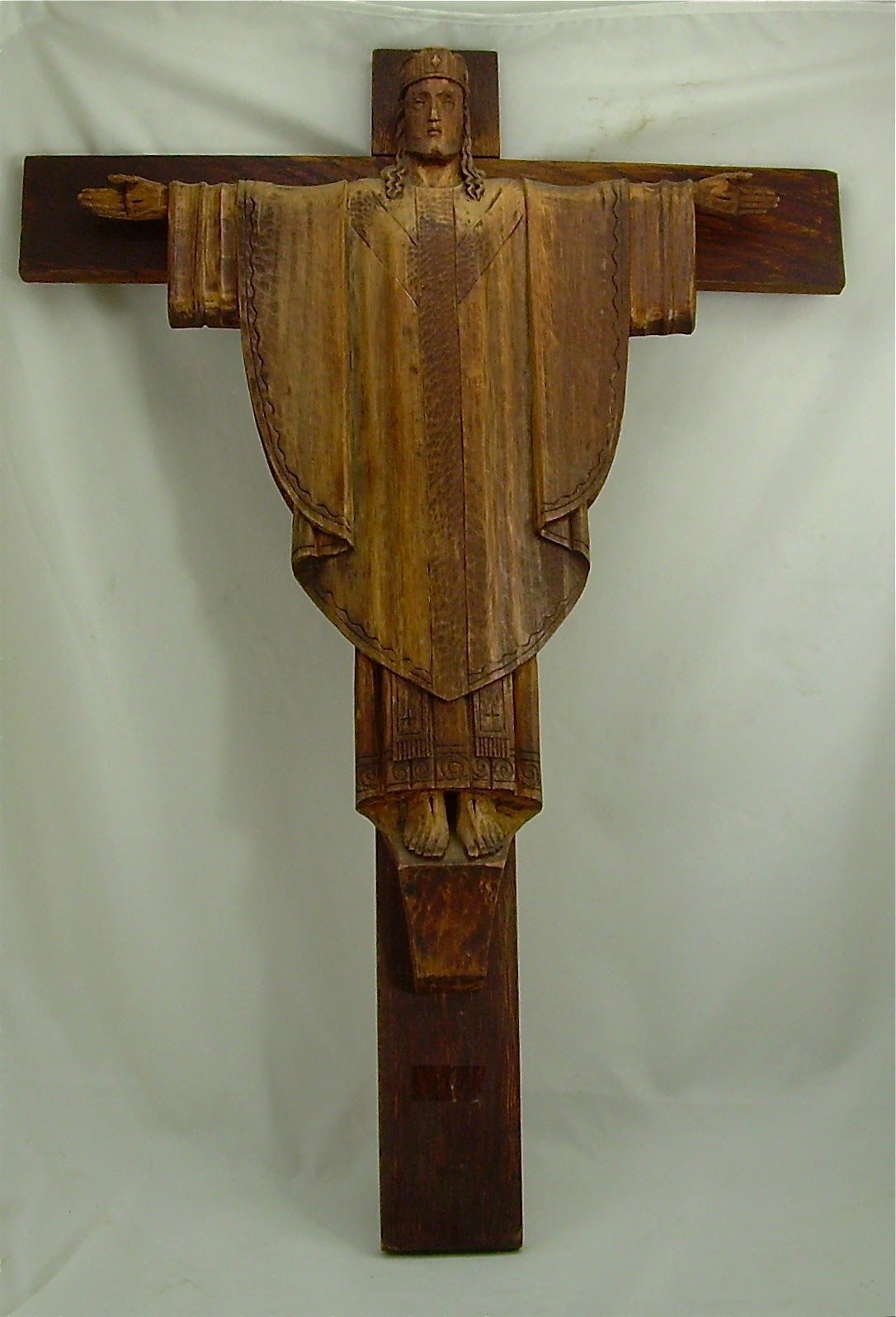 Wooden wall-mounted sculpture with a cross-like shape and carved center panel