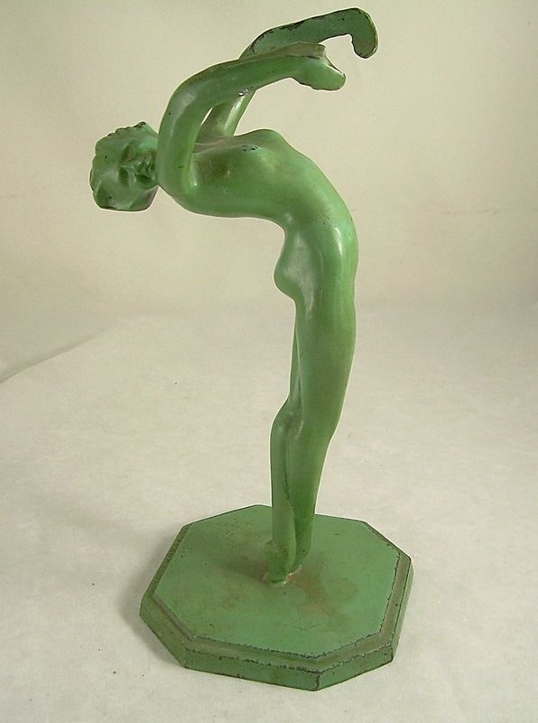 Green abstract dancer figurine on an octagonal base