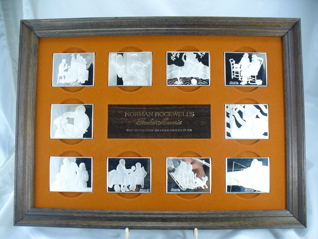 Framed plaque with nine small black-and-white photos on an orange background